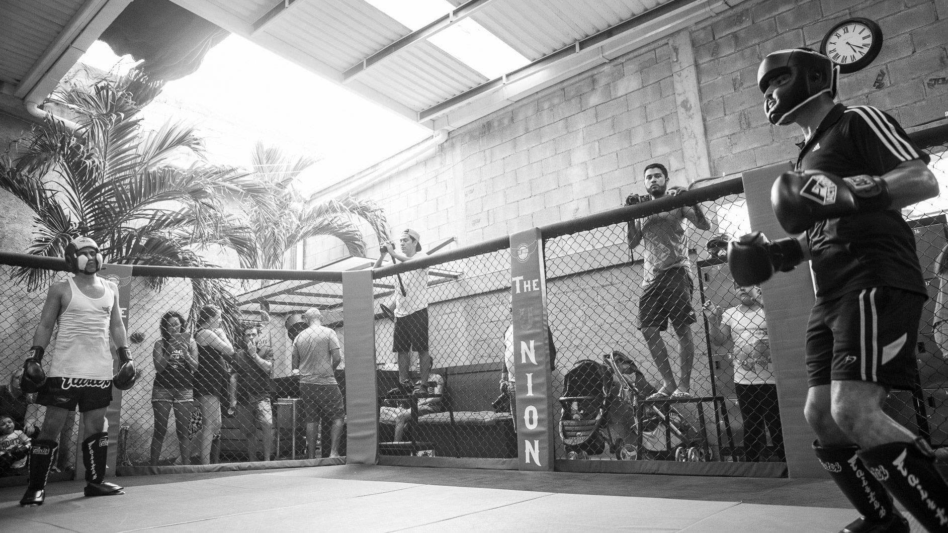 Old-school Muay Thai and Boxing training floor at The Union Gym in Playa del Carmen, featuring authentic Golden Era training environment with professional boxing cage